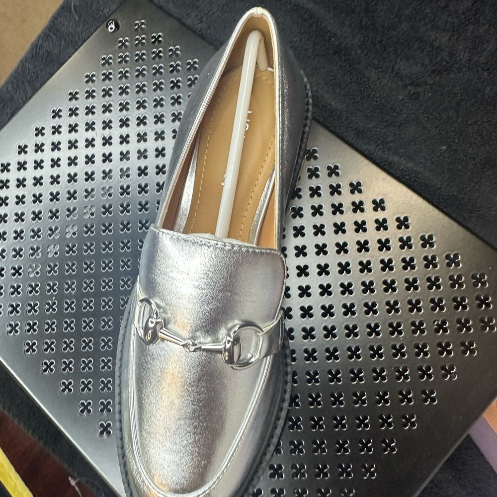 129 133. Silver Metallic Flats with Horsebit Detail
