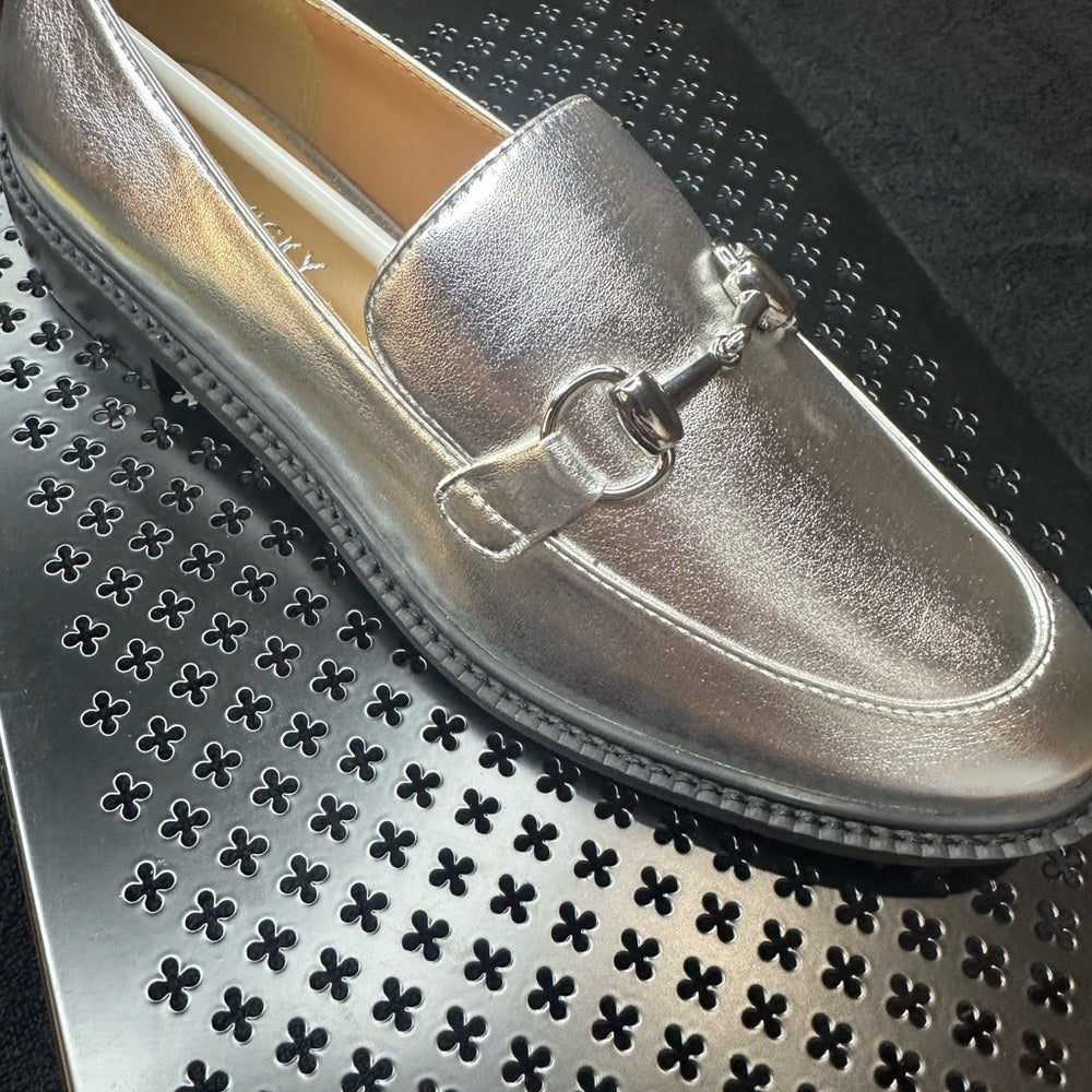 129 133. Silver Metallic Flats with Horsebit Detail
